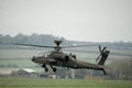 Military helicopter landing in a field Royalty Free Stock Photo