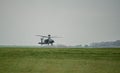 Military helicopter landing in a field Royalty Free Stock Photo