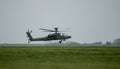 Military helicopter landing in a field Royalty Free Stock Photo