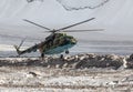 Military helicopter landing on ice of mountain glacier Royalty Free Stock Photo