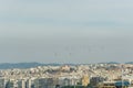 Military helicopters flying above a city.