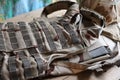 A military helmet of a Ukrainian soldier with a heavy bulletproof vest on wooden table in checkpoint dugout