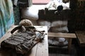 A military helmet of a Ukrainian soldier with a heavy bulletproof vest on wooden table in checkpoint dugout