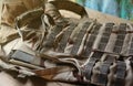 A military helmet of a Ukrainian soldier with a heavy bulletproof vest on wooden table in checkpoint dugout