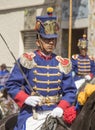 Military honor guard in historic uniforms march in parade on horseback