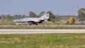 Military jet aircraft brakes after landing by opening the tail parachute