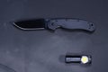 Military knife and flashlight. Black knife and black flashlight