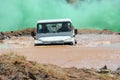 Military Landrover driving through muddy water