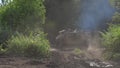 Military machine infantry driving on road at shooting range back view