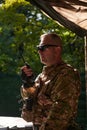 A military major employs a Motorola radio for seamless communication with his fellow soldiers during a tactical