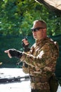 A military major employs a Motorola radio for seamless communication with his fellow soldiers during a tactical