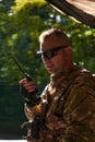 A military major employs a Motorola radio for seamless communication with his fellow soldiers during a tactical