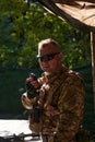 A military major employs a Motorola radio for seamless communication with his fellow soldiers during a tactical