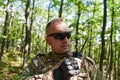 A military major employs a Motorola radio for seamless communication with his fellow soldiers during a tactical