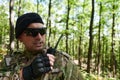 A military major employs a Motorola radio for seamless communication with his fellow soldiers during a tactical