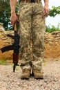 A military man in a military body armor with a tactical Kalashnikov automatic machine gun in his hands. Royalty Free Stock Photo