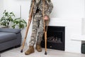 military man with crutches, disability