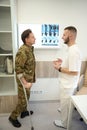 Military man discussing results of his computed tomography with traumatologist Royalty Free Stock Photo