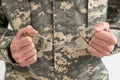 a military man is holding handcuffs