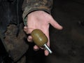 Volunteer in Ukrainian camouflage hold grenade.