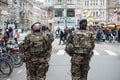 Military mens patroling in the street whit shotguns