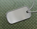 Military metal id tag on a steel background