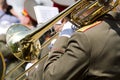 Military musician playing gold trombone on parade Royalty Free Stock Photo