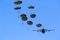 Military parachutist paratroopers jumping out of an air force airplane Royalty Free Stock Photo