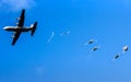 Military parachutist paratroopers jumping from a US Air Force C-130 Hercules plane during the Operation Falcon Leap. Veluwe, The