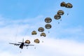 Military parachutist paratroopers parachute jumping out of an air force plane