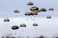 Military parachutist paratroopers parachute jumping out of an air force plane