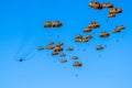 Military parachutist paratroopers parachute jumping out of a air force planes on a clear blue sky day Royalty Free Stock Photo