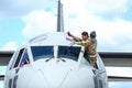 A military pilot of an Alenia C-27J Spartan military cargo plane from the Italian Air Force is cleaning the windscreen of the