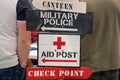 military police and Army Checkpoint sign on wooden panel arrow aid post and canteen Royalty Free Stock Photo