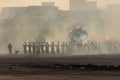 Military police riot response to a protest with tear gas, smoke, fire, explosions. Political expression, riot, protest,