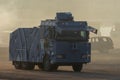 Military police vehicles enforcing law and order in protest, war, and conflict driving across the desert