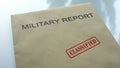 Military report classified, seal stamped on folder with important documents Royalty Free Stock Photo