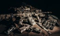 Military rifle laying on table with tactical gear