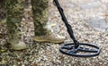 Military sapper with a metal detector in the field. Explosive Ordnance Disposal Officer