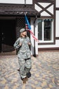 Military servicewoman with backpack leaving house