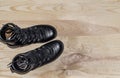 Military shoes boots on the background light polished board. Uniform, protection of soldiers, reliable shoes Royalty Free Stock Photo