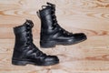 Military shoes boots on the background light polished board. Uniform, protection of soldiers, reliable shoes Royalty Free Stock Photo