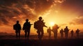 The military silhouettes of soldiers hold gun against with sunset sky background