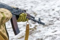 A military soldier in camouflage with a weapon goes on the offensive in winter