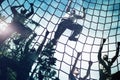 Military soldiers climbing rope during obstacle course