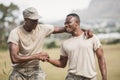 Military soldiers shaking hands during obstacle course