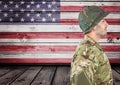 Military standing against american flag Royalty Free Stock Photo