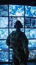 A military strategist studies a wall of monitors each screen a window into the complexities of global security Royalty Free Stock Photo
