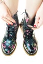 Military style boots with flowers decoration on an hands with po