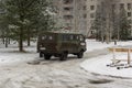 A military-style medical car drives up to hospital on broken winter road